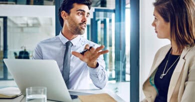 un homme avec son ordinateur dialogue avec une femme